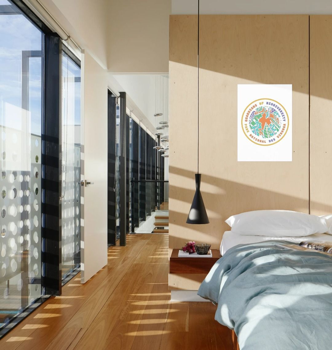 A Guardians of Biodiversity Poster featuring the logo of Virunga National Park with a colorful emblem on a hall in the bedroom