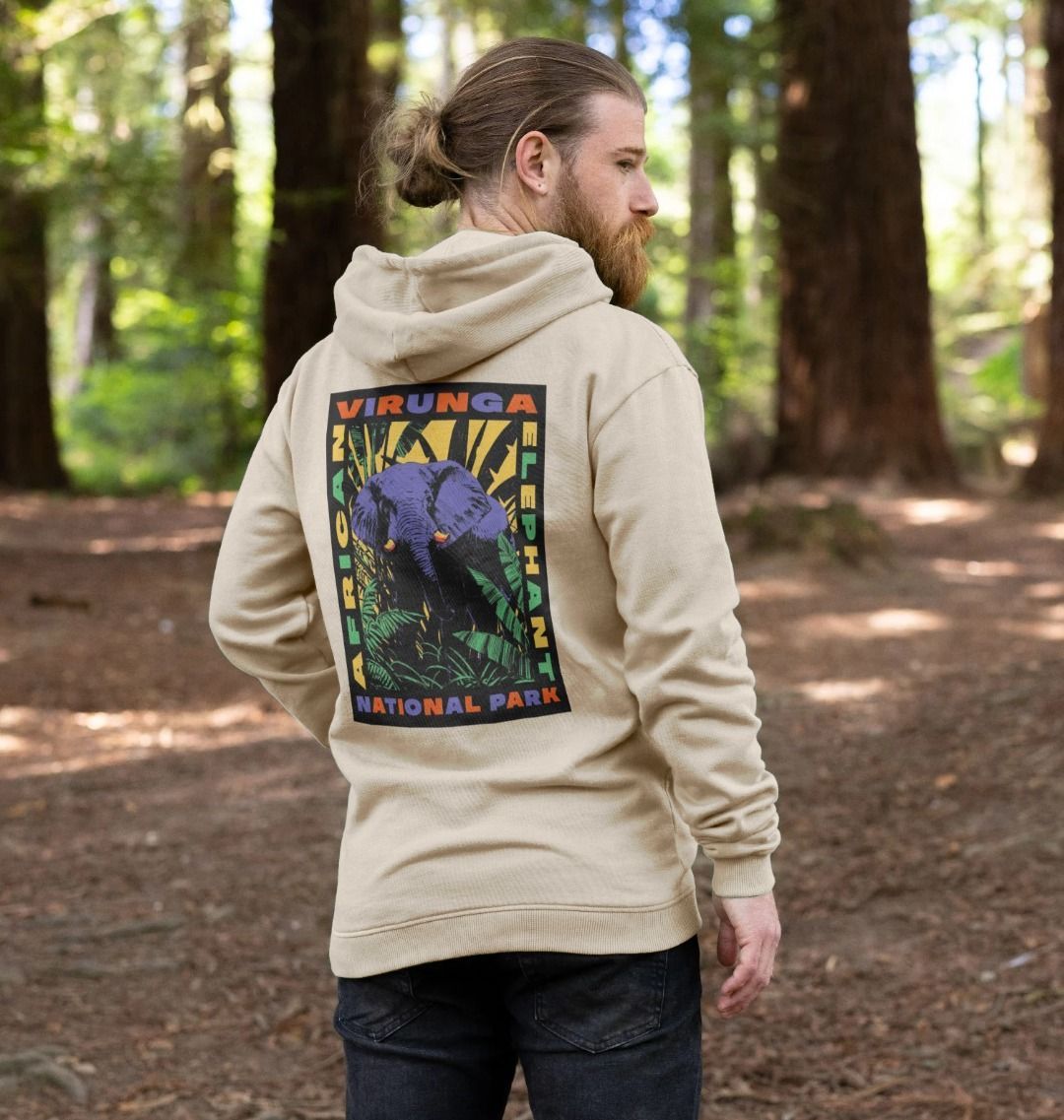 A man wearing a beige Retro Elephant Men's Hoodie, standing in a forest. (back)