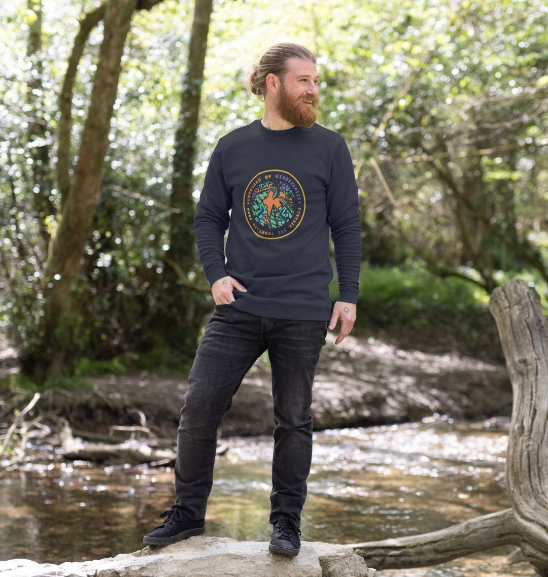 A man wearing a navy blue guardian's of biodiversity men's sweater
