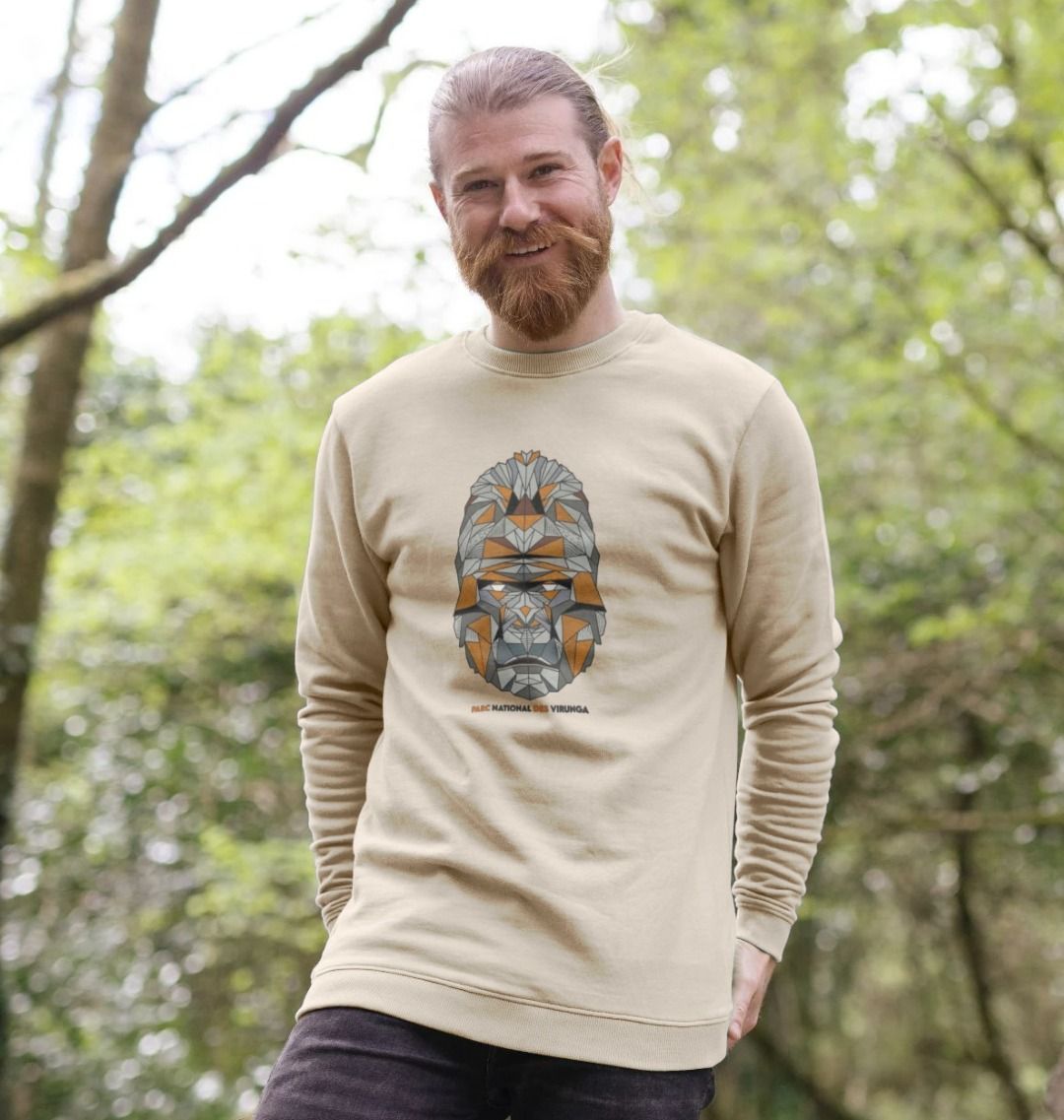 A man wearing an oat Gorilla Face Men's Sweater in a forest setting