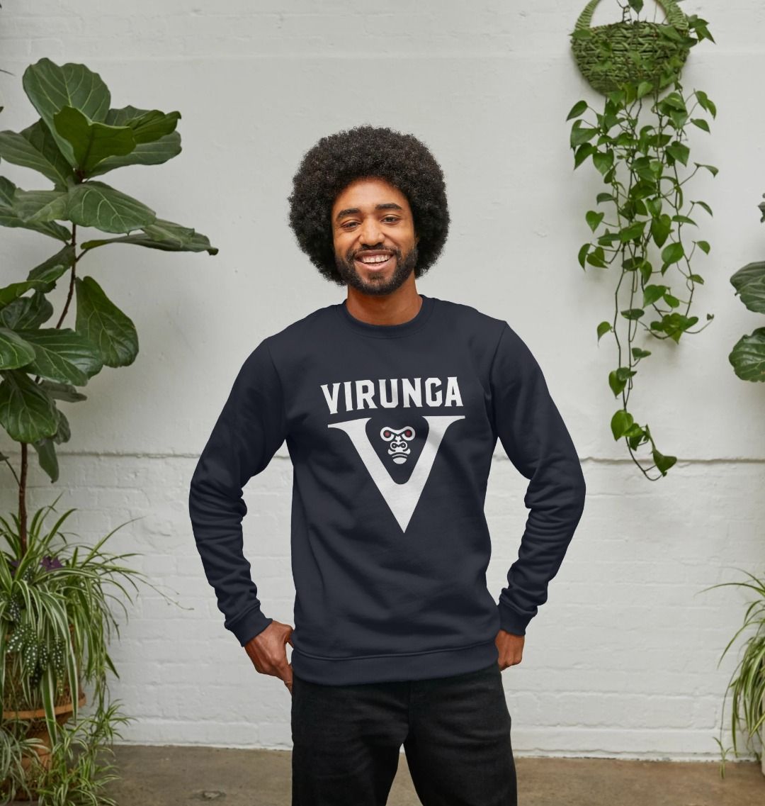 A man wearing navy blue V for Virunga Men's Sweater