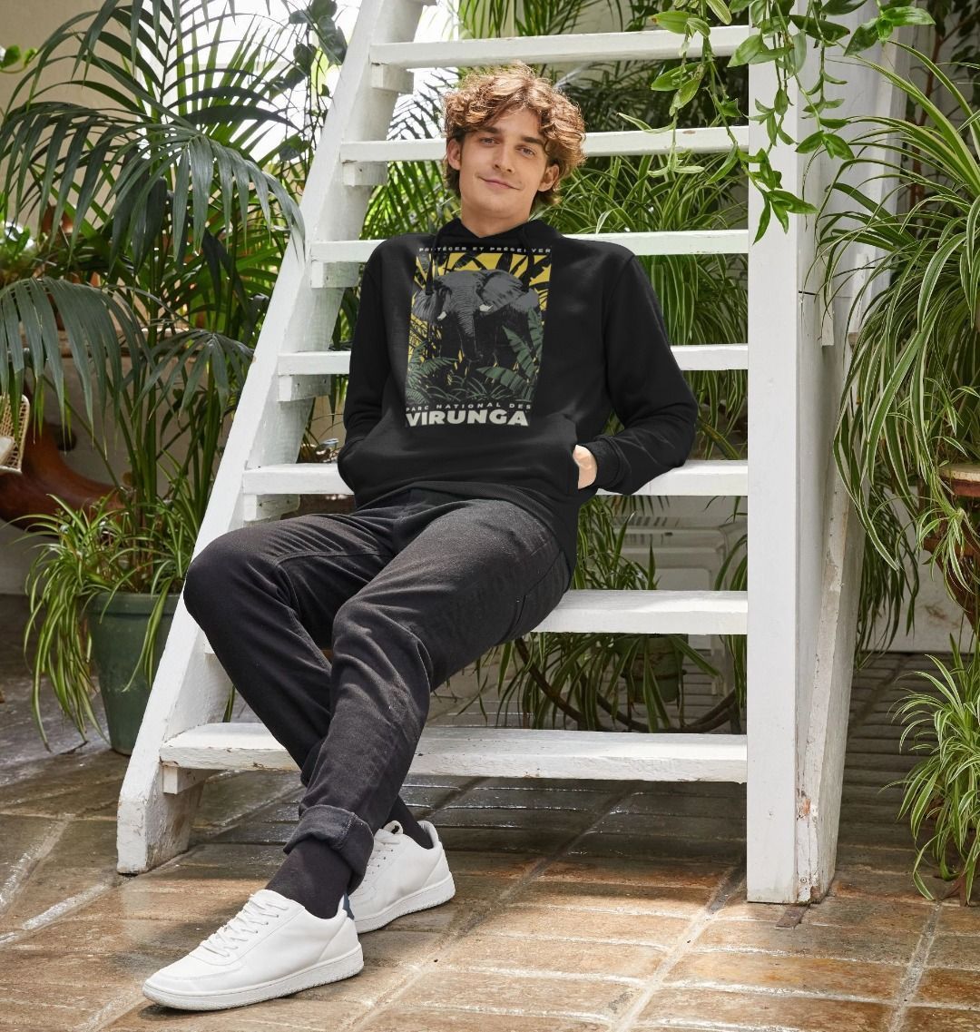 A white man wearing a black African Elephant Yellow Print Men's Hoodie