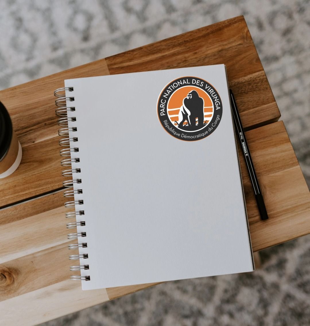Virunga Logo Sticker on a White Notebook