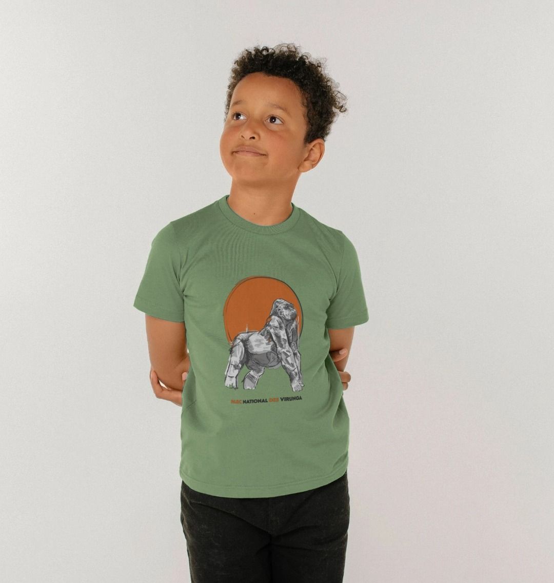 A Kid wearing an sage Ndakasi Kids T-shirt in the forest