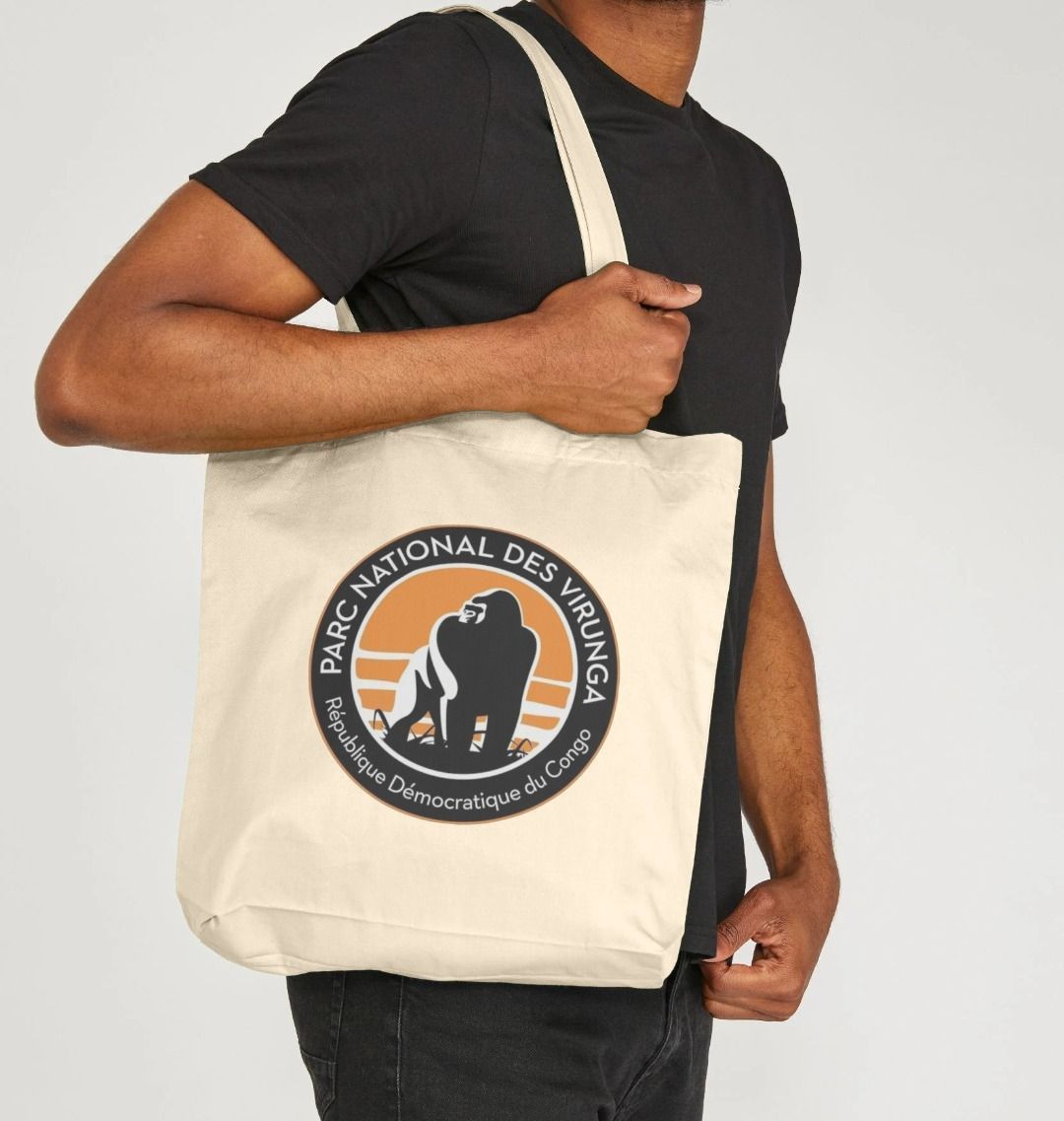 A Man Holding a Beige Virunga National Park Tote Bag