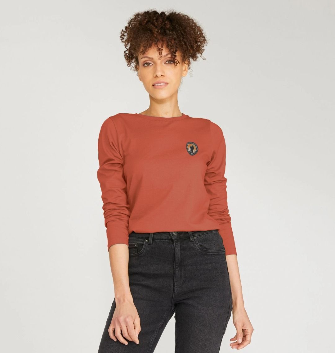 A White Women Wearing a Red Virunga Pocket Logo Women's Long Sleeve T-shirt