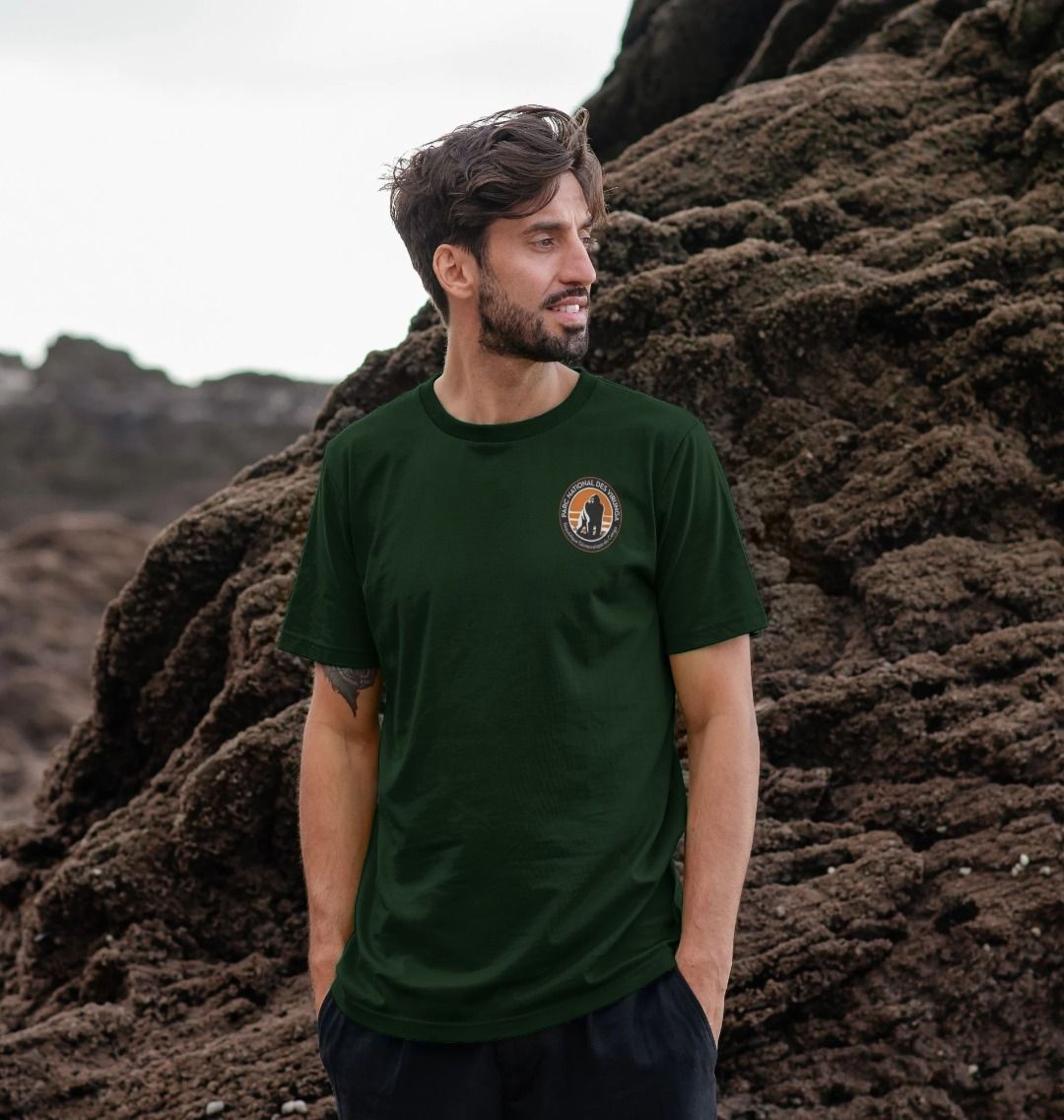 A man wearing an evergreen virunga pocket logo men's t-shirt