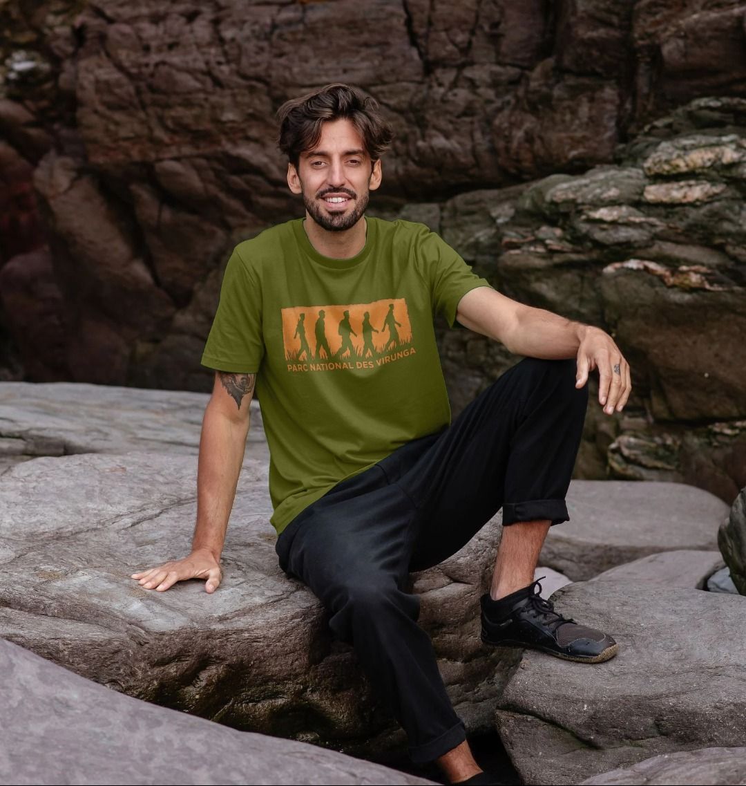 A man wearing a moss green Virunga Rangers Men's T-shirt.