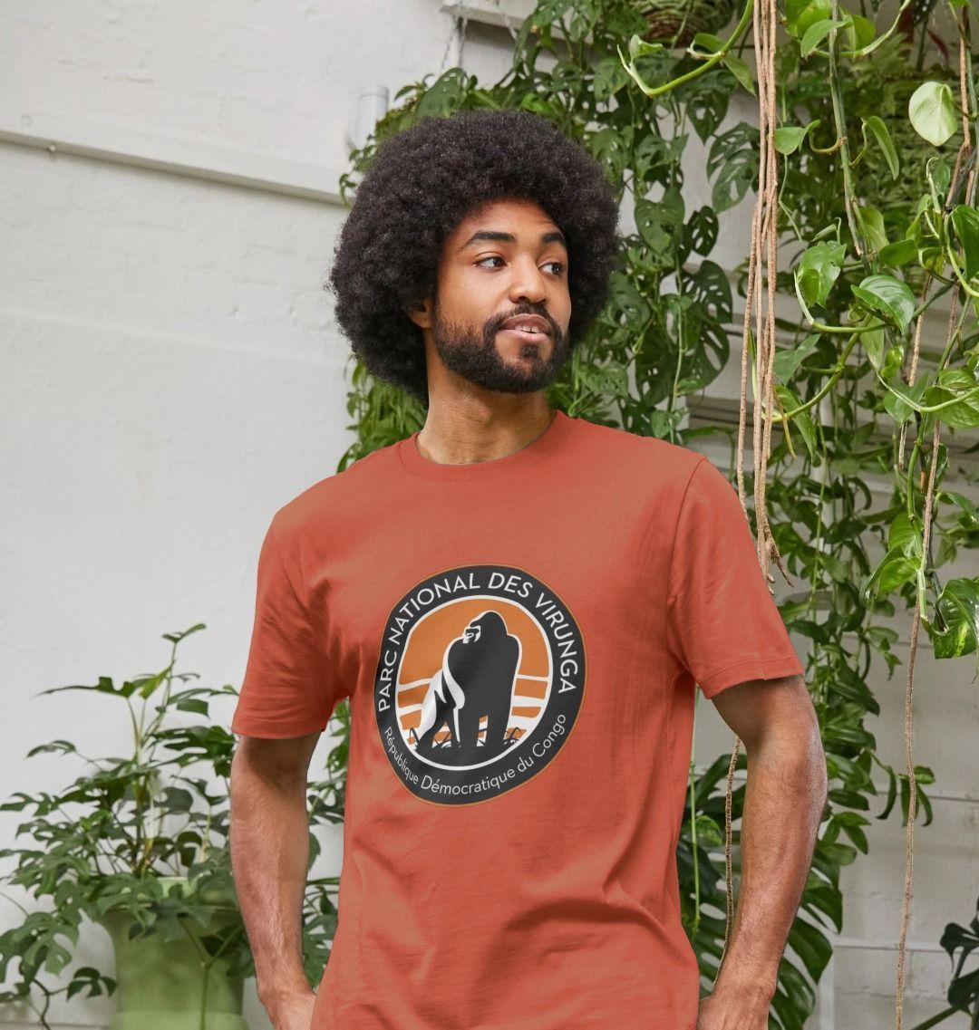 A man wearing a rust Virunga Logo Men's T-shirt standing