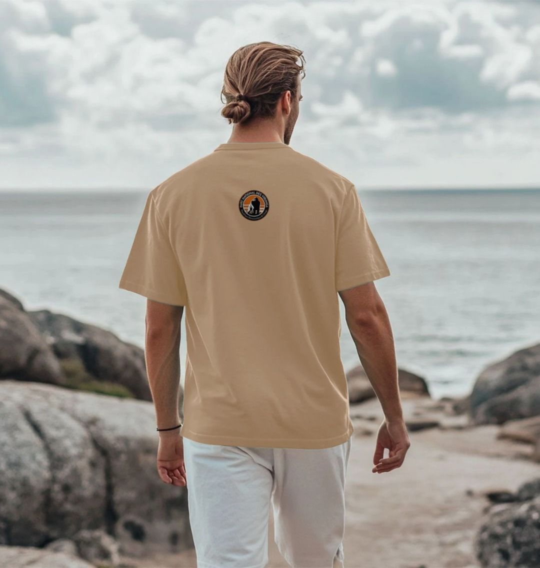 A man wearing a sand bageni family men's t-shirt.