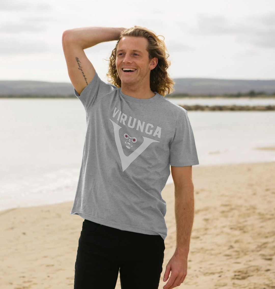 A man wearing an athletic grey V for Virunga Men's T-shirt on the plage 