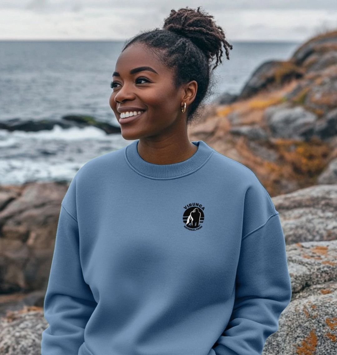 A person wearing a Solent Virunga oversized jumper standing by the coast.