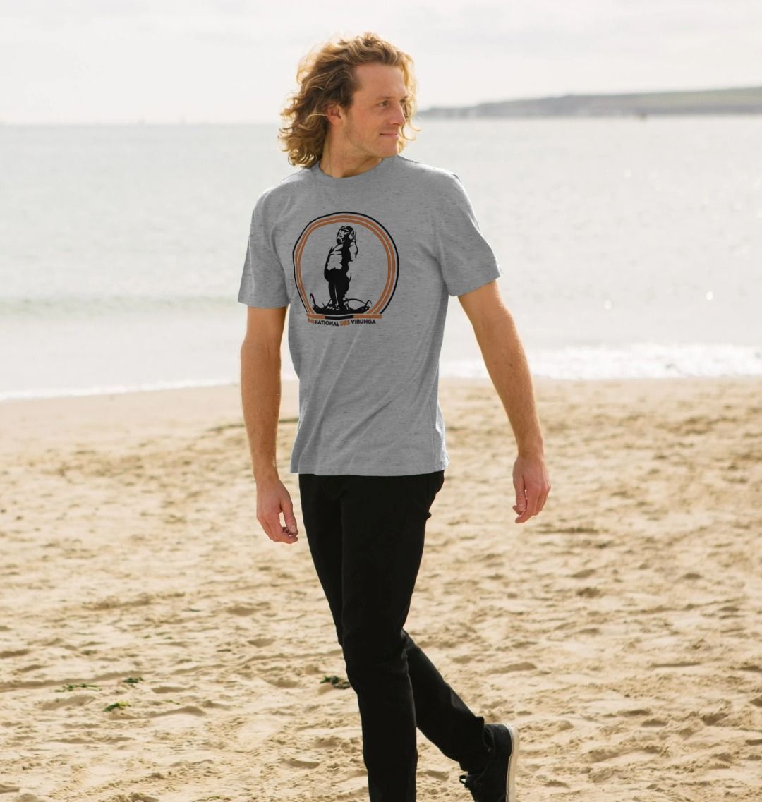 A white man wearing a light heather Take A Stand Men's T-shirt