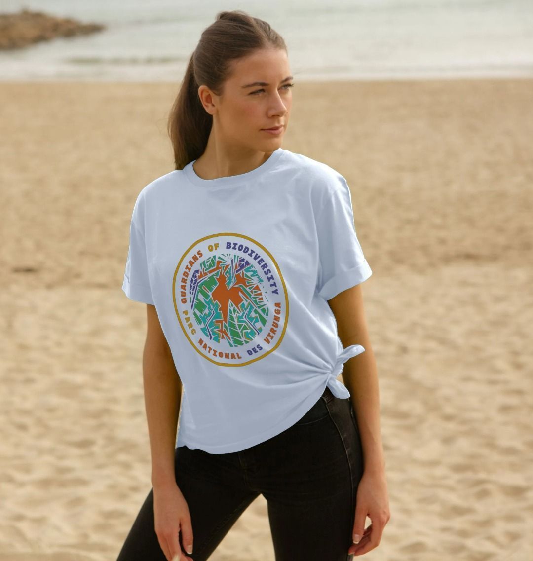 A woman on a plage wearing a white Guardians of Biodiversity Women's Relaxed Tee