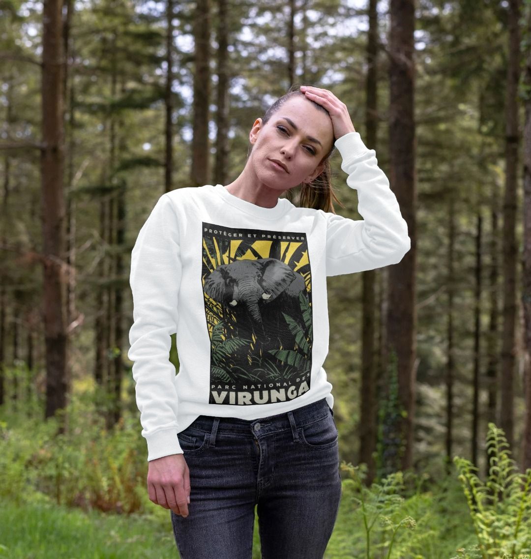A woman standing in a forest, wearing a white African Yellow Print Women's Sweater.