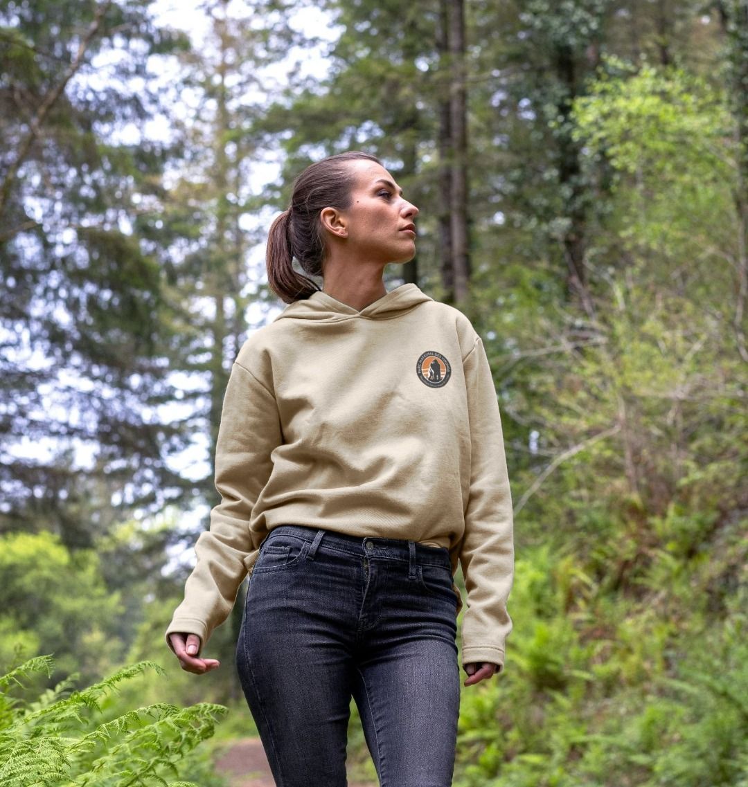 A woman wearing a retro elephant women's hoodie and a black pant