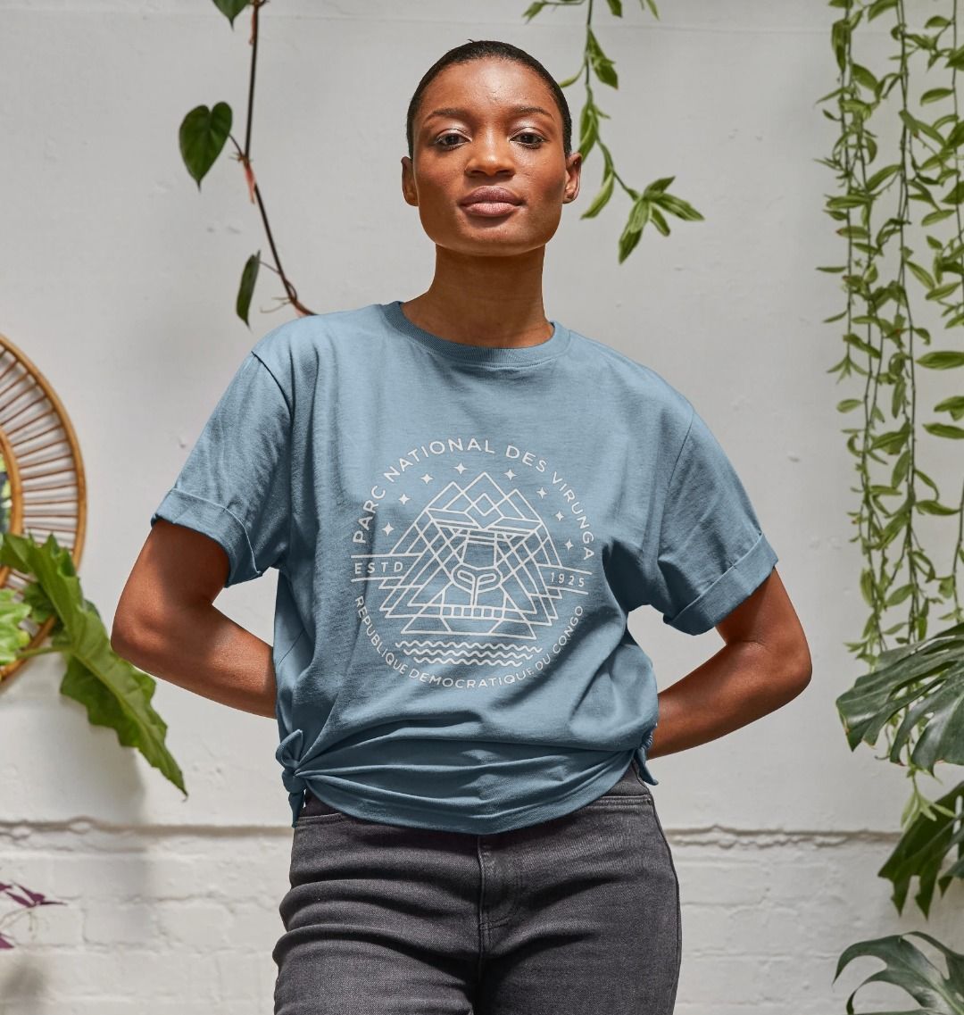 A woman wearing a stone blue Virunga Emblem Women's Relaxed Tee