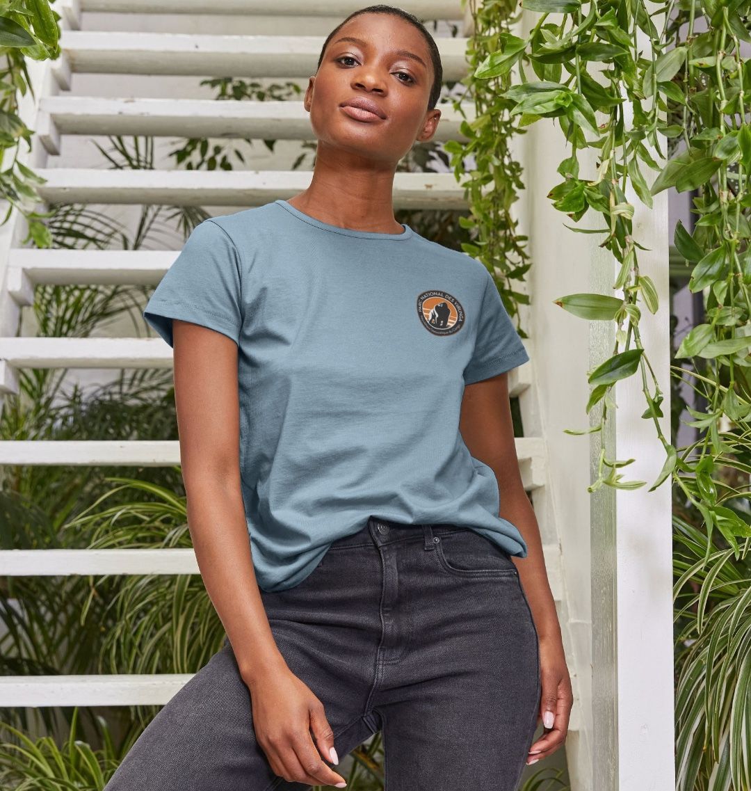 A woman wearing a stone blue Virunga Pocket Logo Women's Top.
