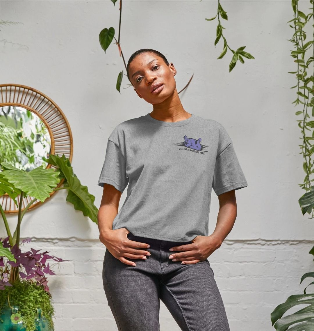 A woman wearing an athletic grey hippo women's boxy tee