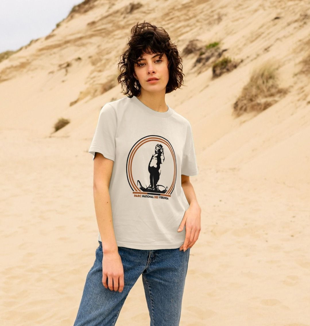 A woman wearing an oat Take A Stand Women's T-shirt in a desert