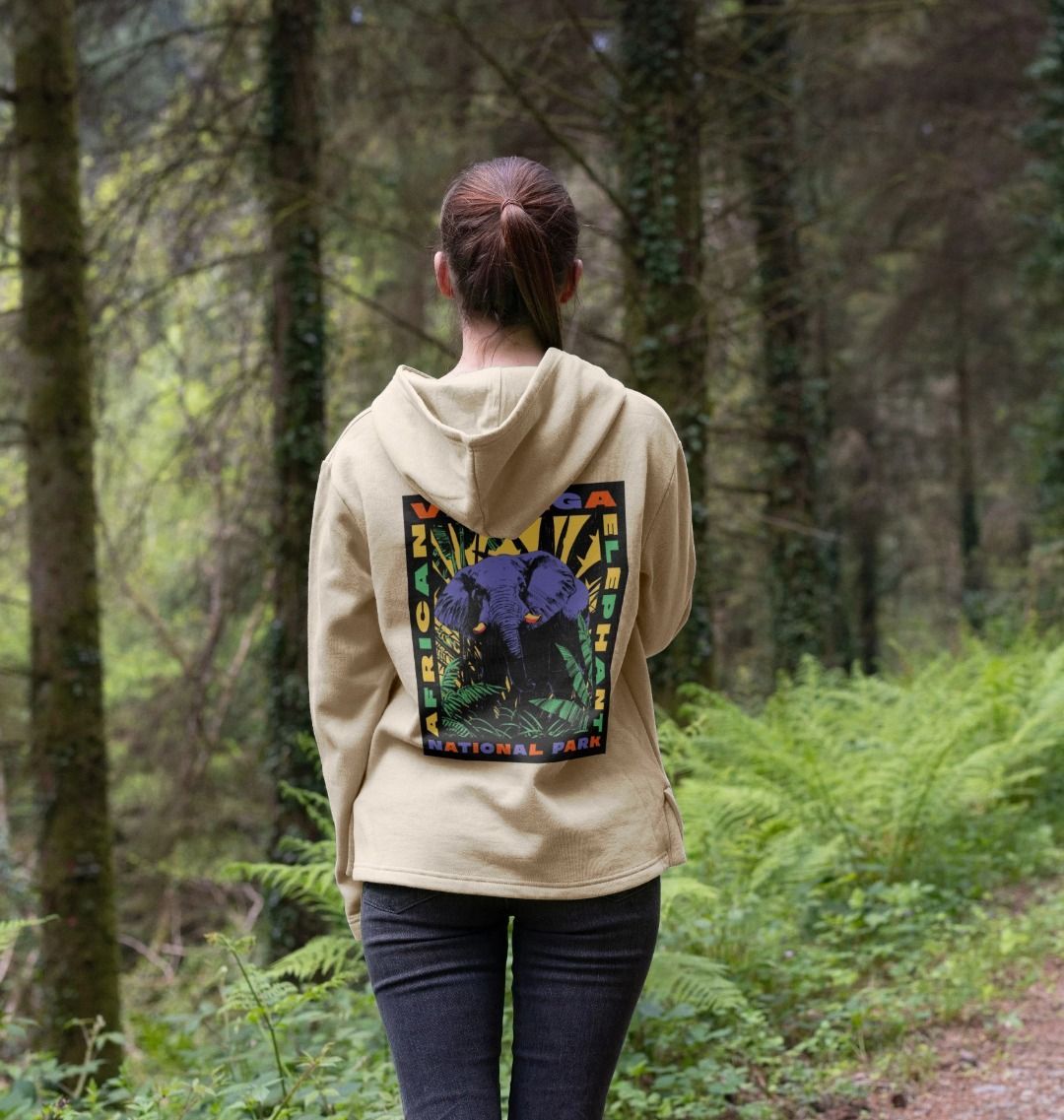 A woman wearing an oat retro elephant women's hoodie
