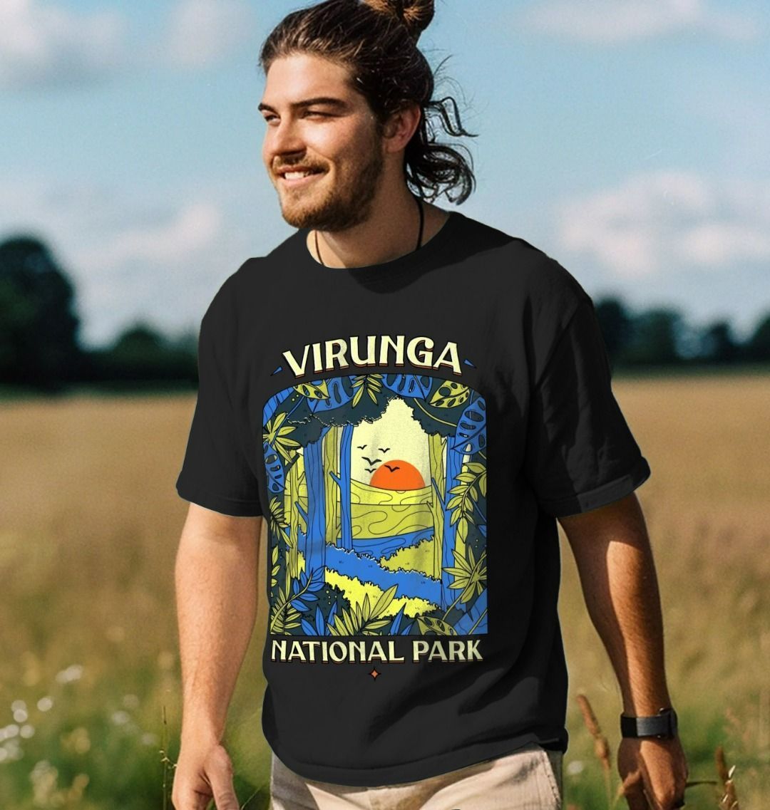 A man standing in a field wearing a black Biodiversity Men's Oversized T-shirt.
