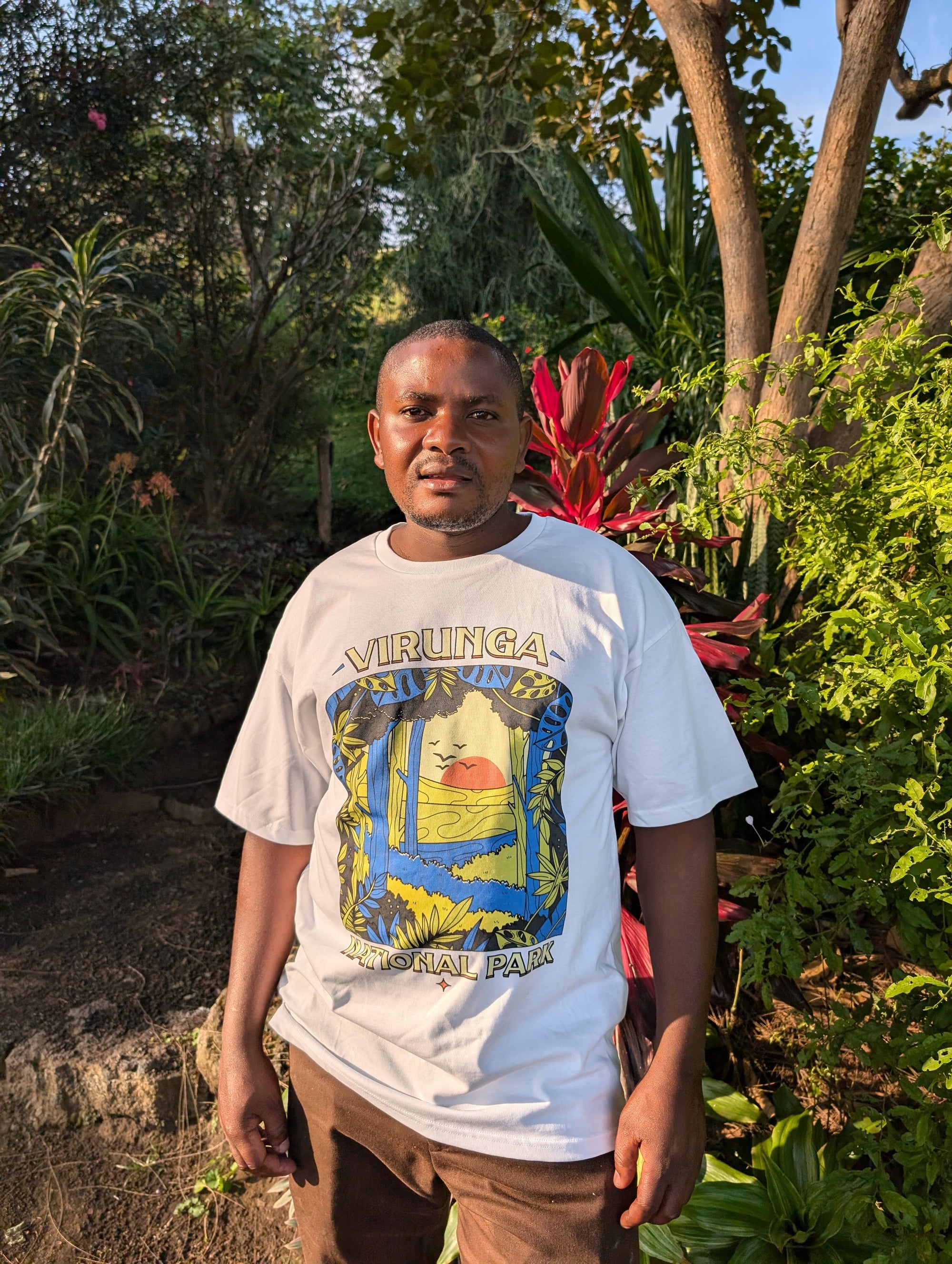 A black man wearing a white Biodiversity Men's Oversized T-shirt