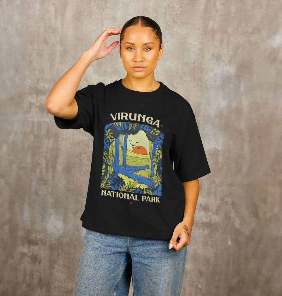 A woman wearing a black Biodiversity Women's Oversized T-shirt