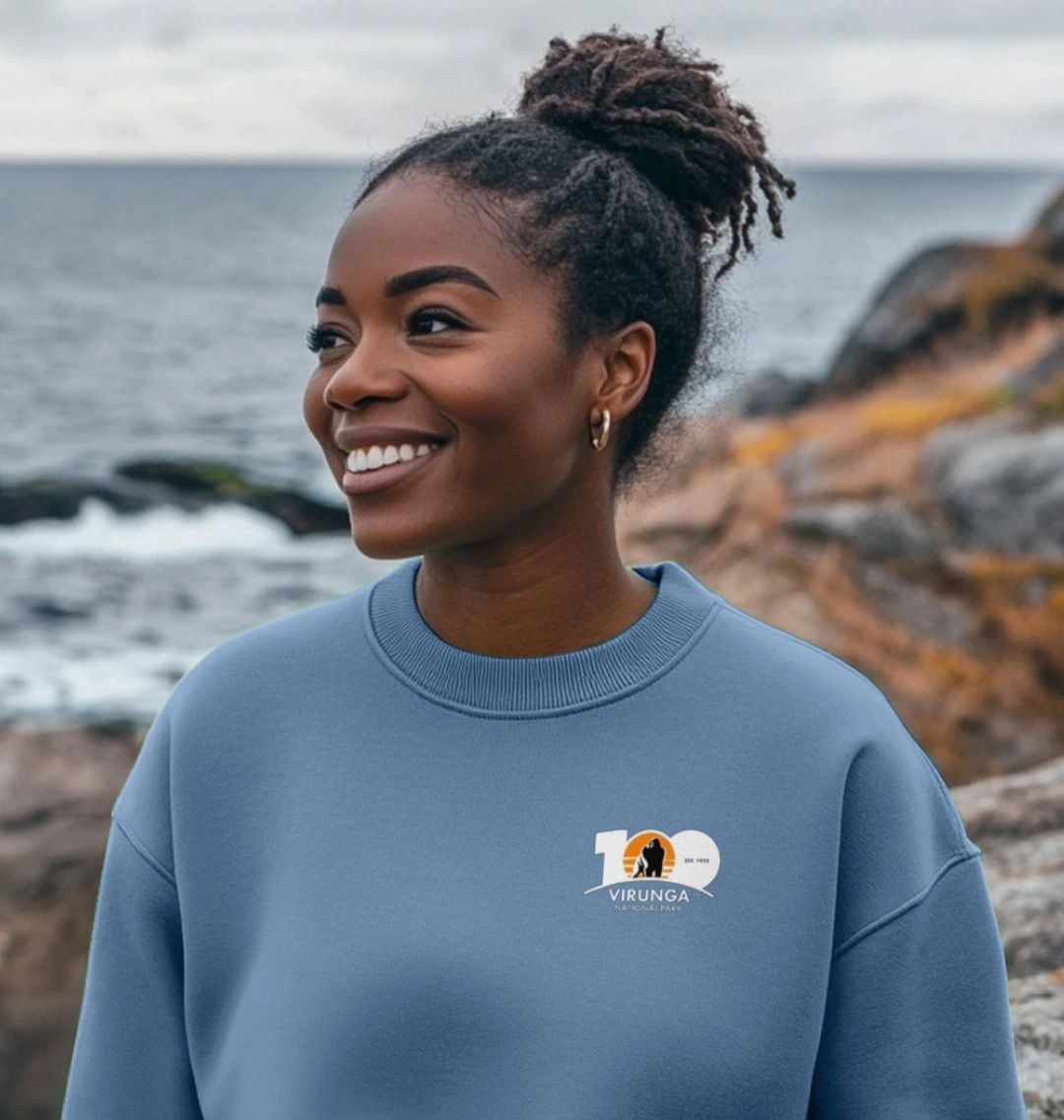 A woman smiling and wearing a Virunga 100 Women's Oversized Jumper.