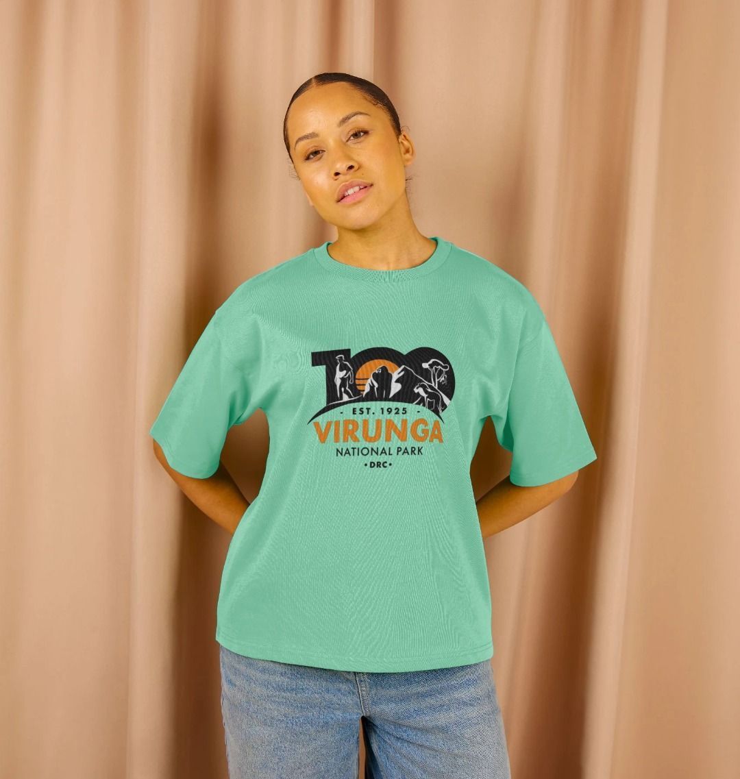 A woman wearing a peppermint Virunga 100 Women's Oversized T-shirt