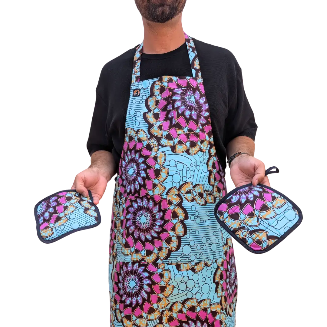 Person wearing a colorful apron holding two matching pot holders 