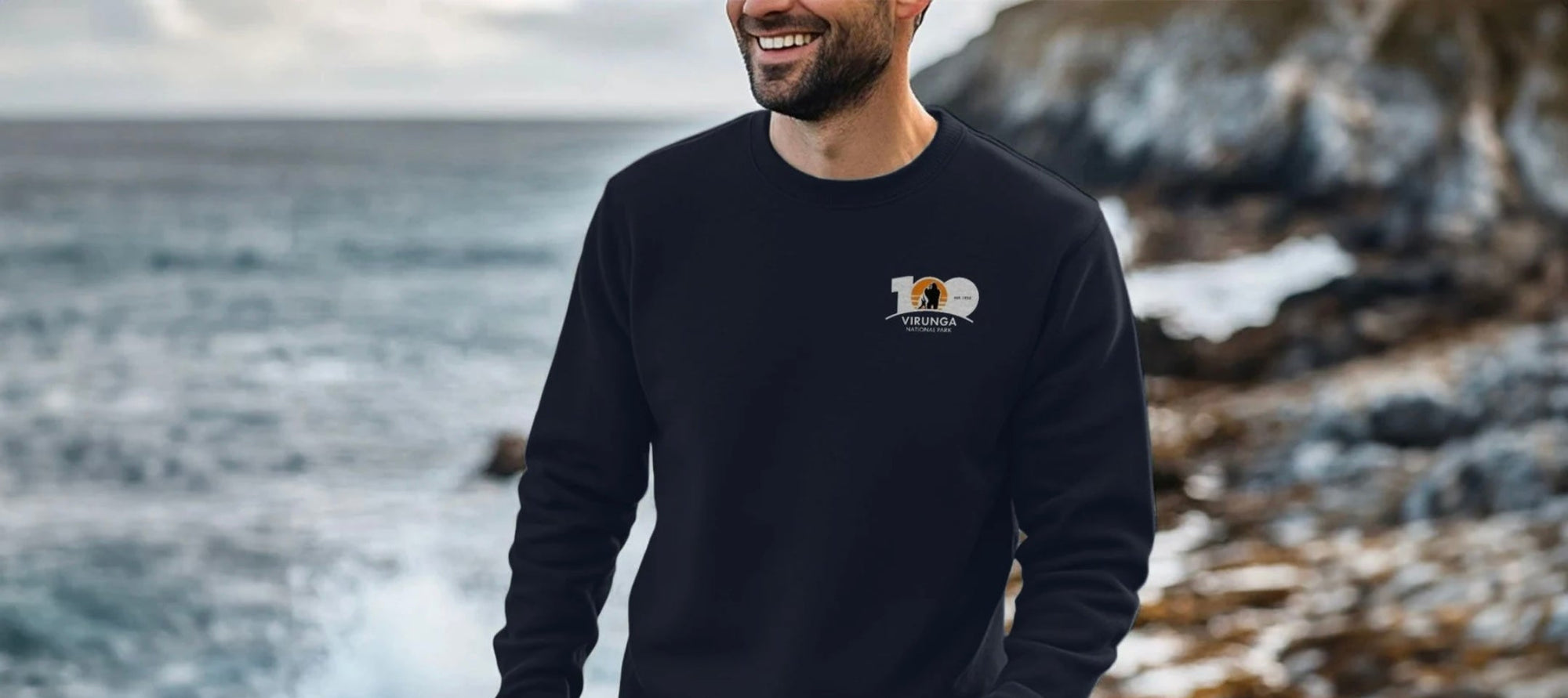 Man wearing a black Virunga Logo sweatshirt.