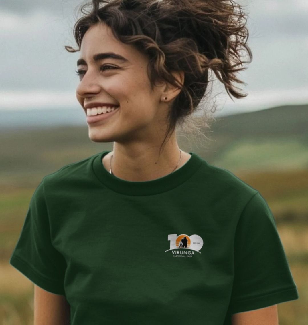 A woman wearing an evergreen Virunga 100 Women's T-shirt