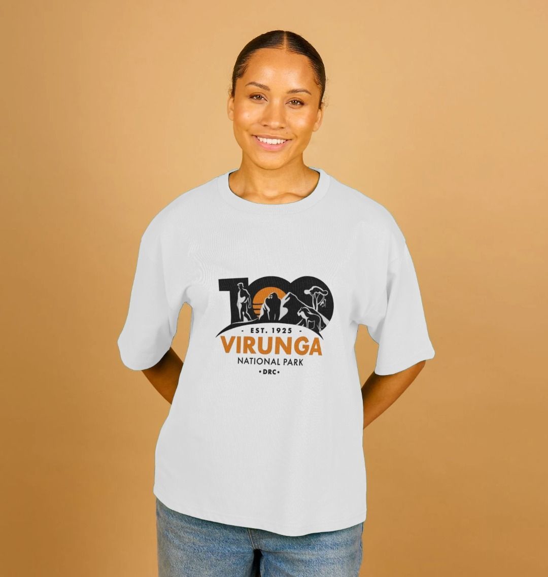 A woman smiling and wearing a white Virunga 100 Women's Oversized T-shirt.