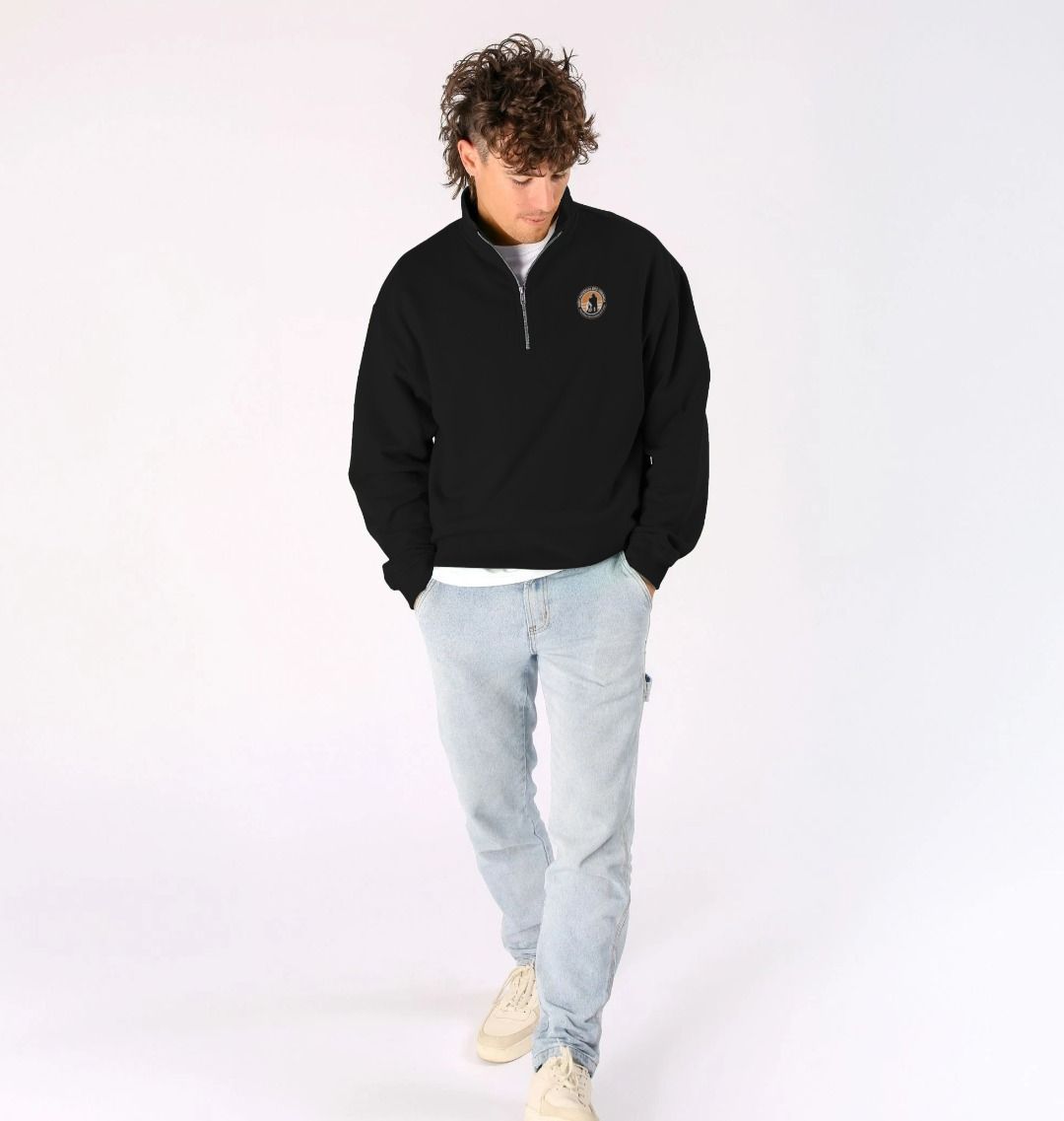 A young man wearing a black Virunga Logo Unisex Sweatshirt